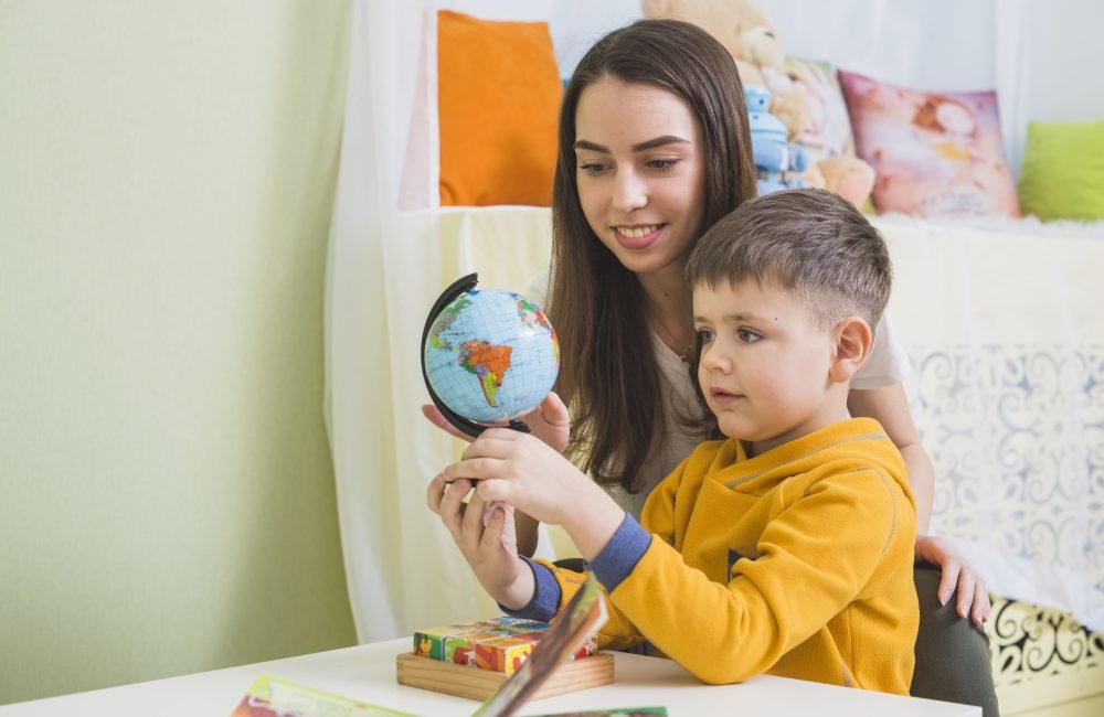 woman-boy-looking-globe